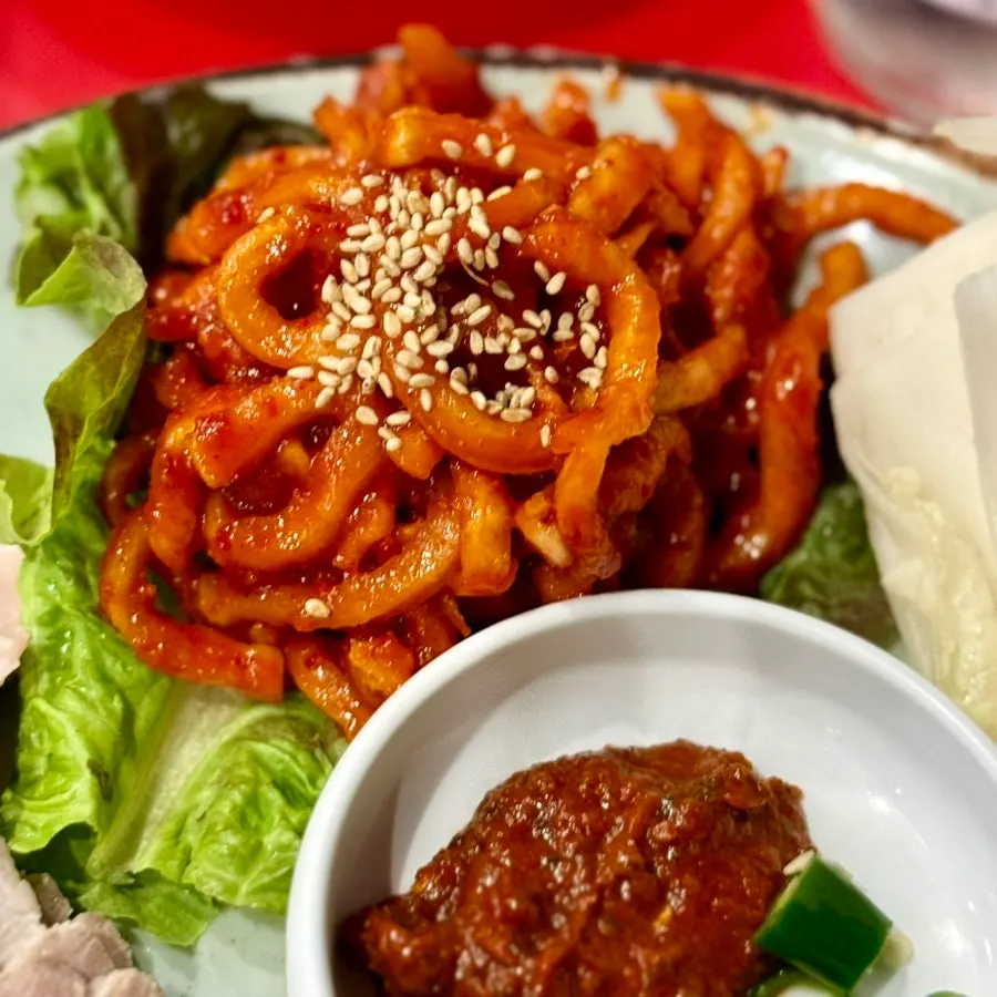 Spicy sauce and radish salad served with bossam