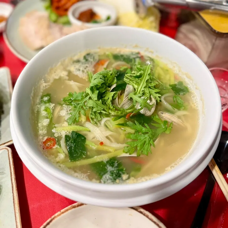 A bowl of the complimentary clam noodle soup
