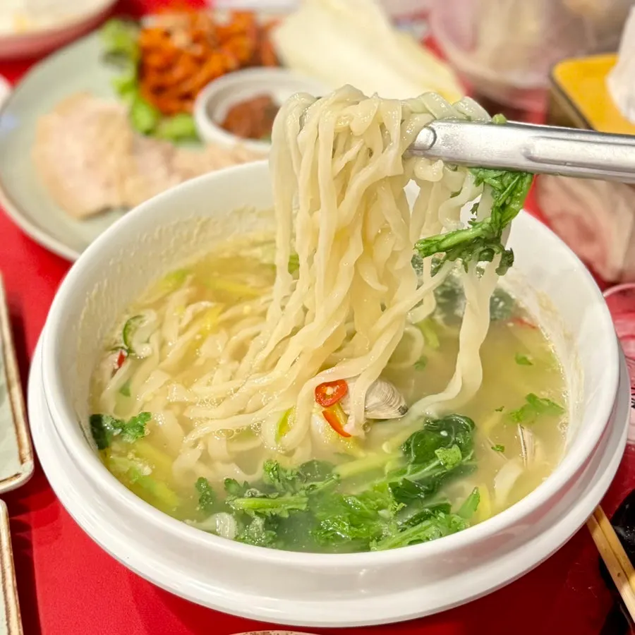 Lifting noodles out of the clam noodle soup