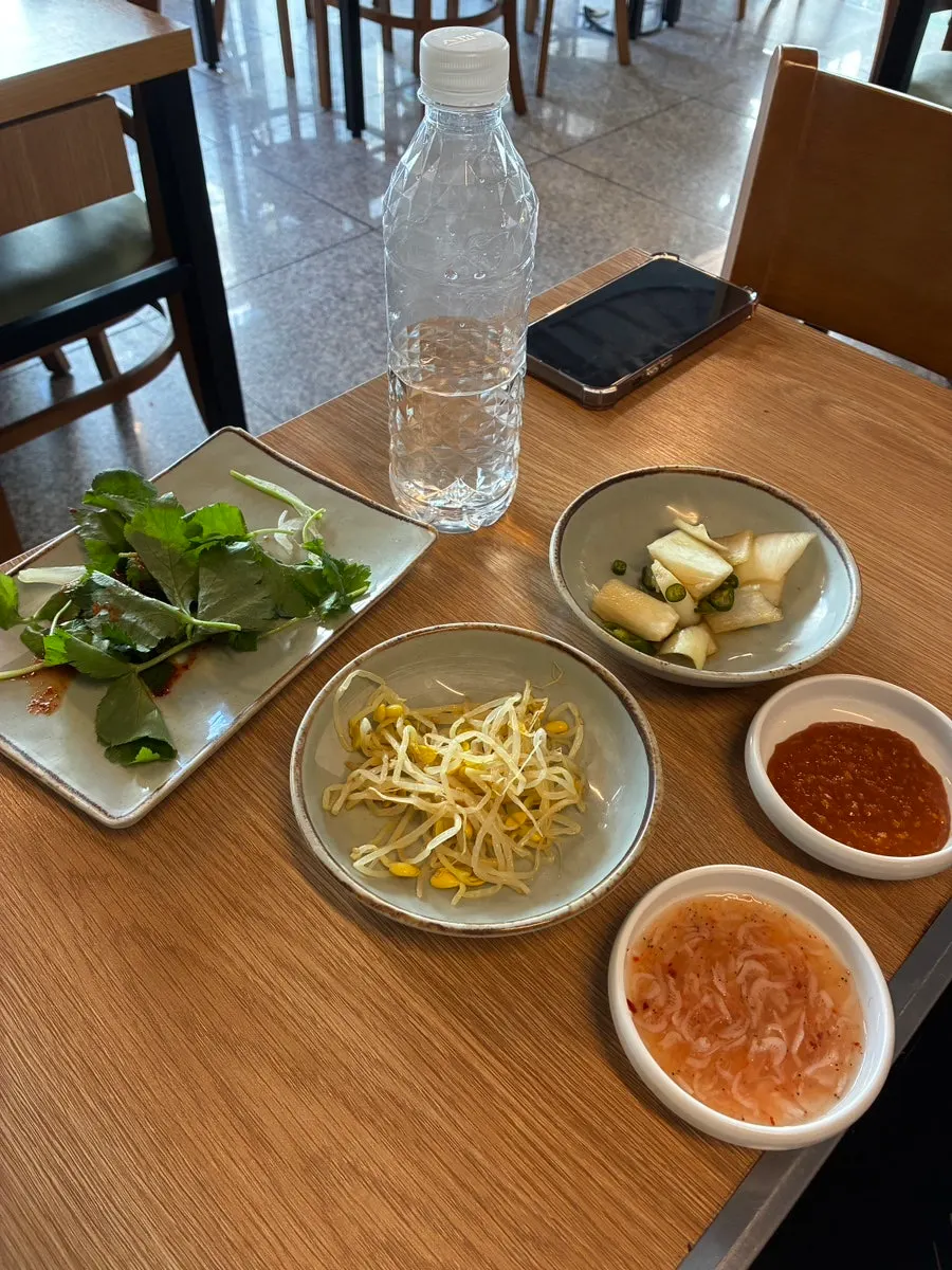Side dishes including kimchi and seasoned bean sprouts