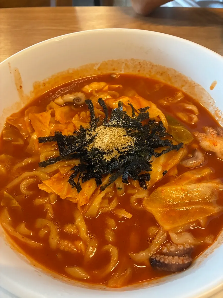 Spicy kalguksu topped with octopus