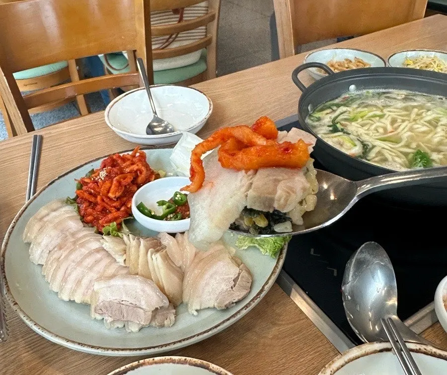 A table set with pickled onion, bean sprouts, and other basic side dishes