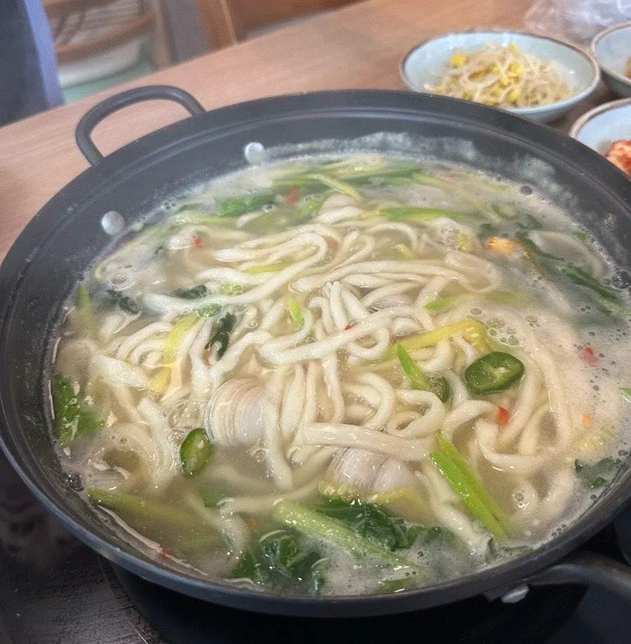 A nearly empty bossam plate and kalguksu bowl