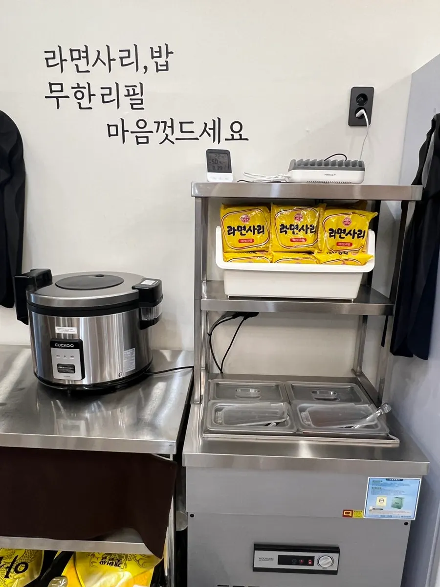 Self-serve bar with ramyeon noodles, rice, and side dishes