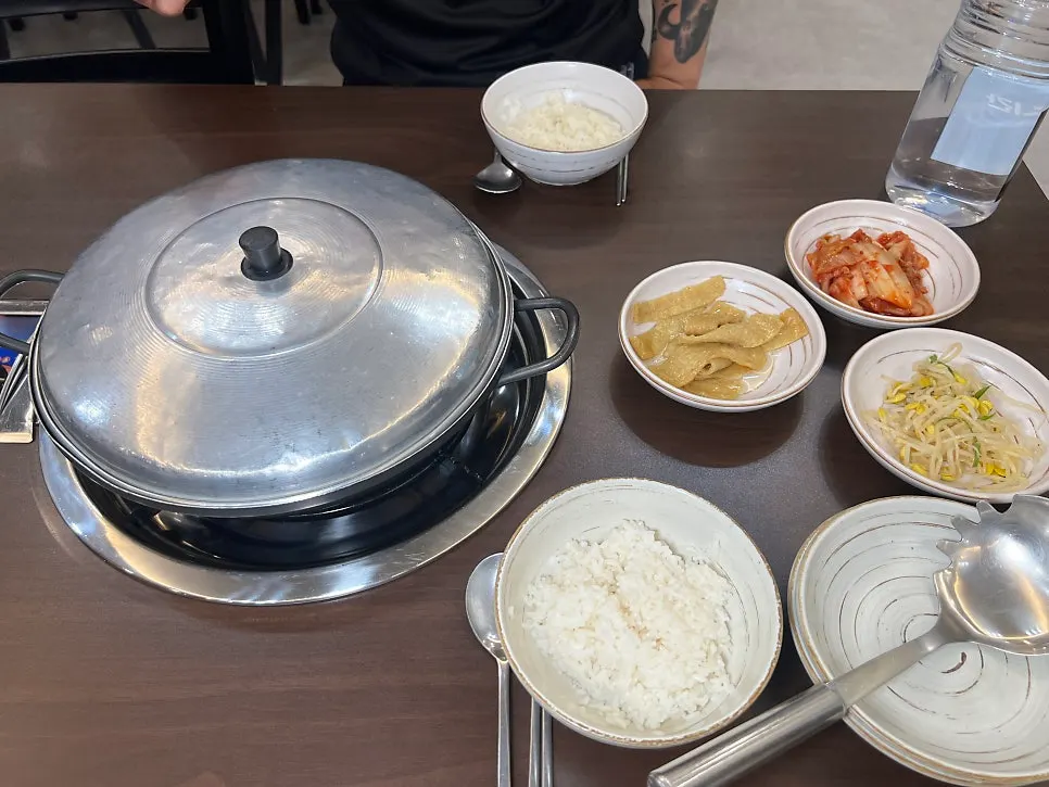 Two servings of Songtan budae-jjigae served with lid on