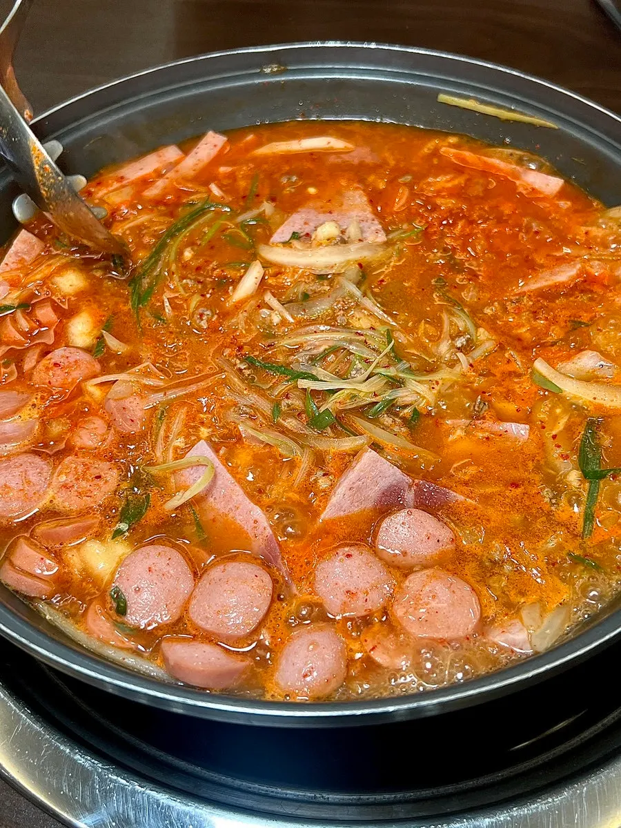 Two servings of Songtan budae-jjigae boiling at Cheongwon