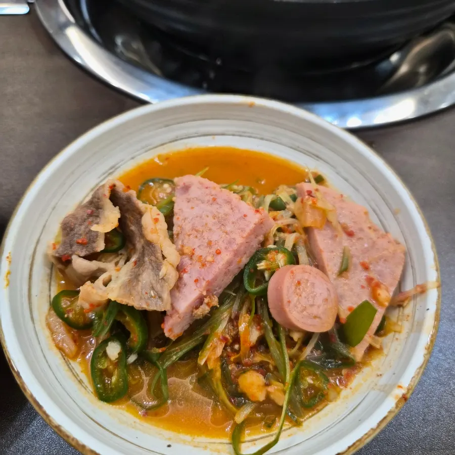 Budae-jjigae ingredients scooped onto a small plate
