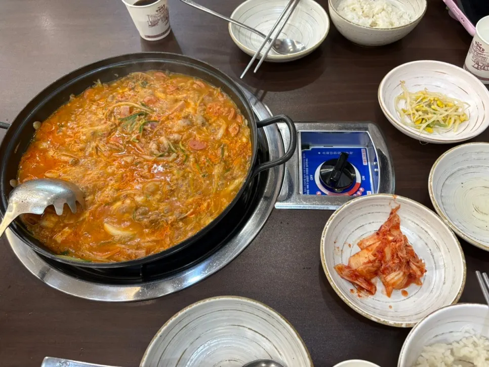Wide shot of the pot packed with budae-jjigae ingredients