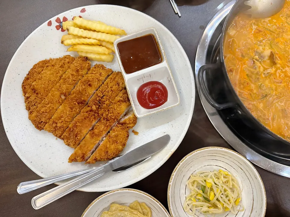 Pork loin cutlet served with fries and sauce