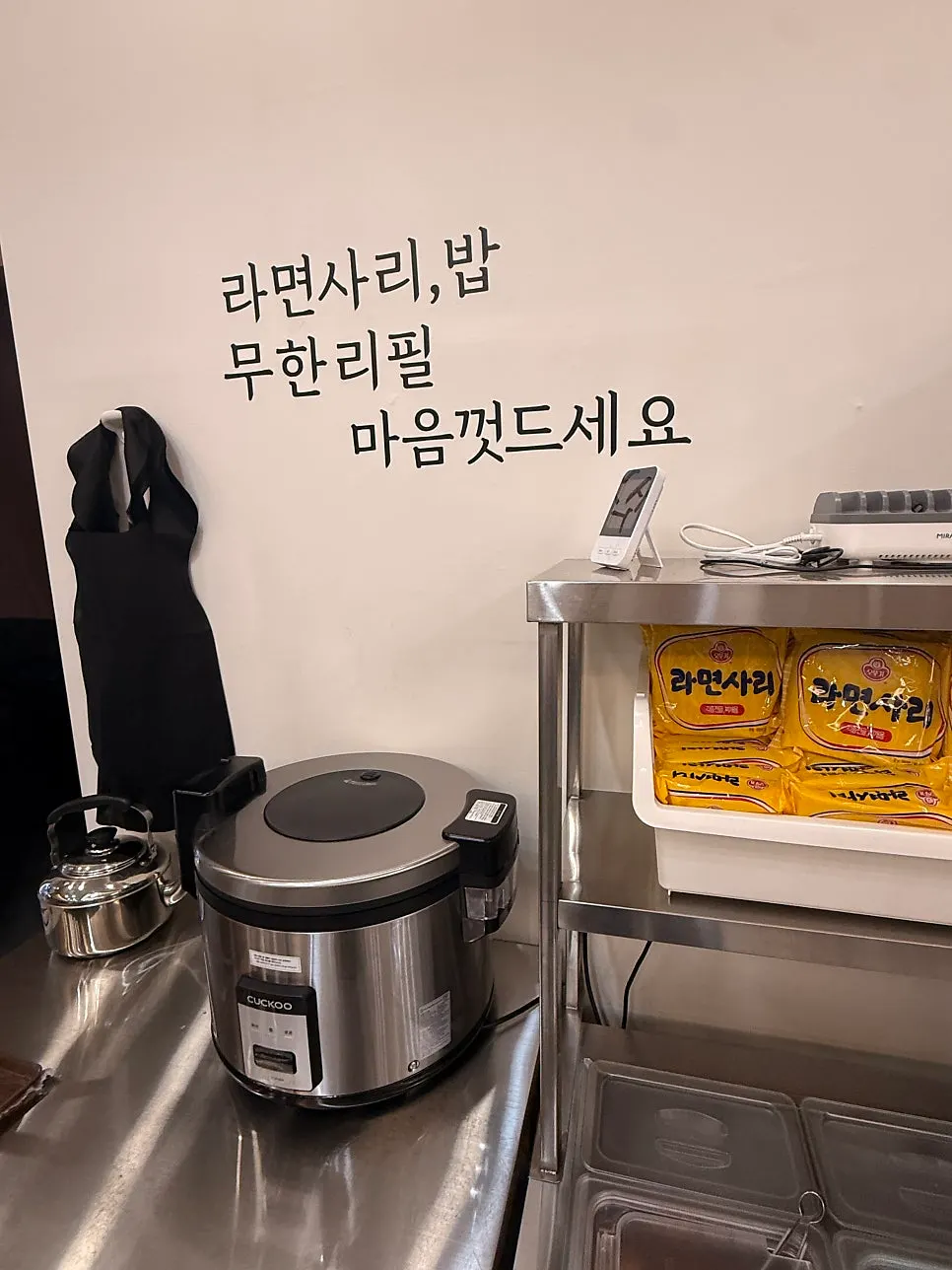 Rice and banchan containers at the self-serve corner