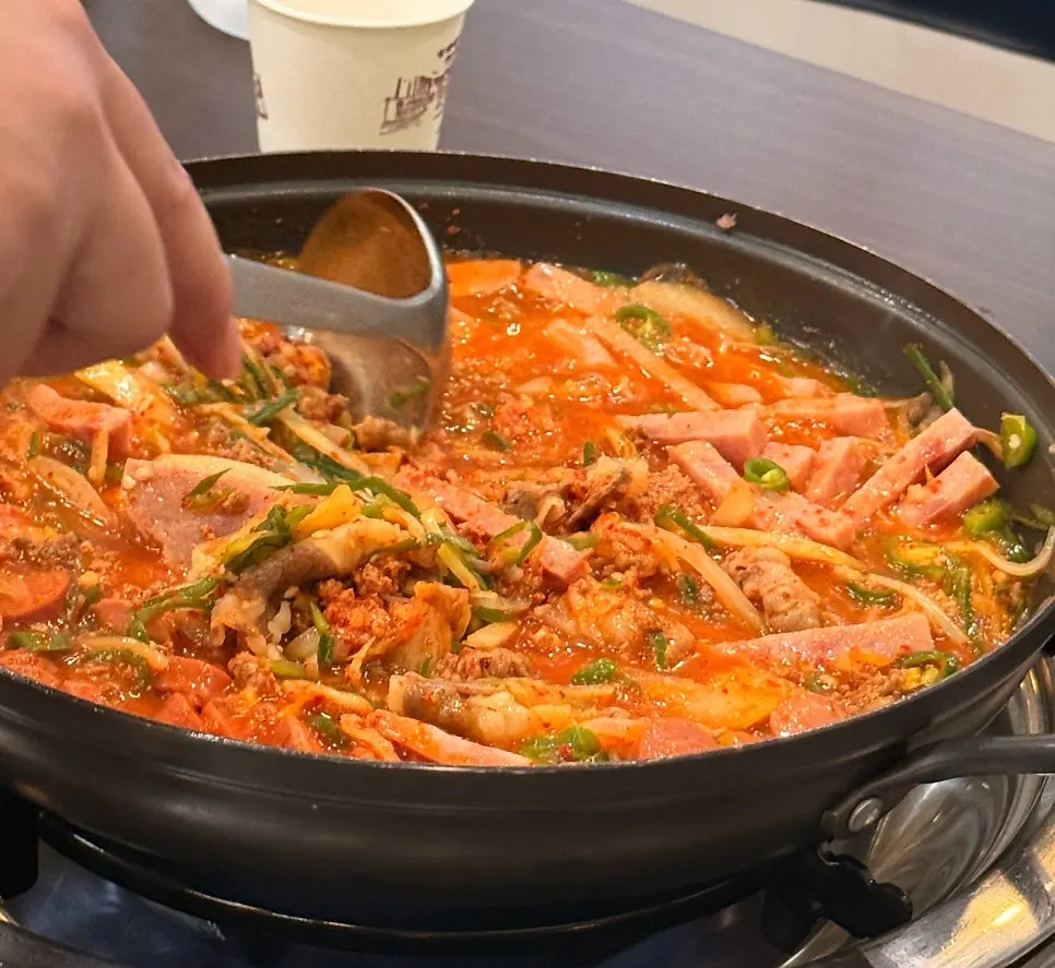 Budae-jjigae broth with ham and beef brisket