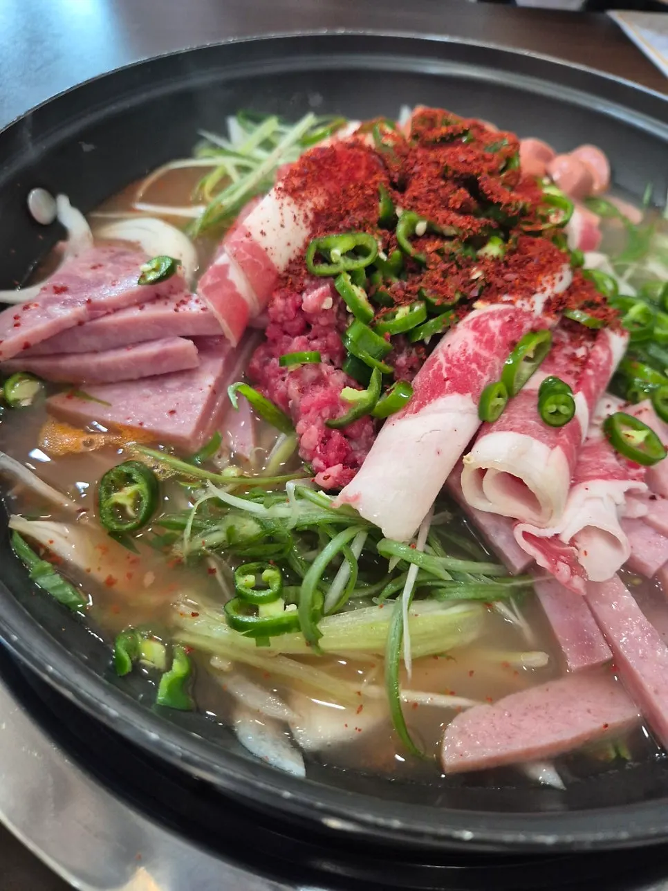 Cheongwon budae-jjigae loaded with beef brisket before boiling