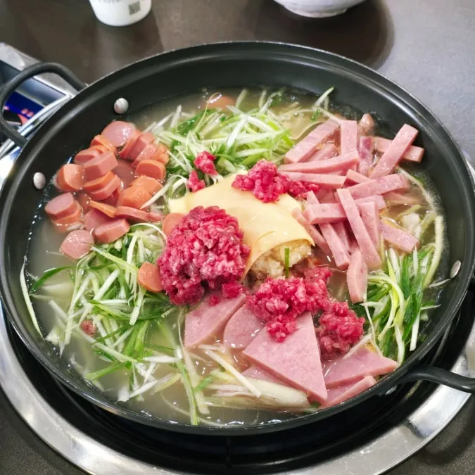 Budae-jjigae left with the lid on until staff came to stir it