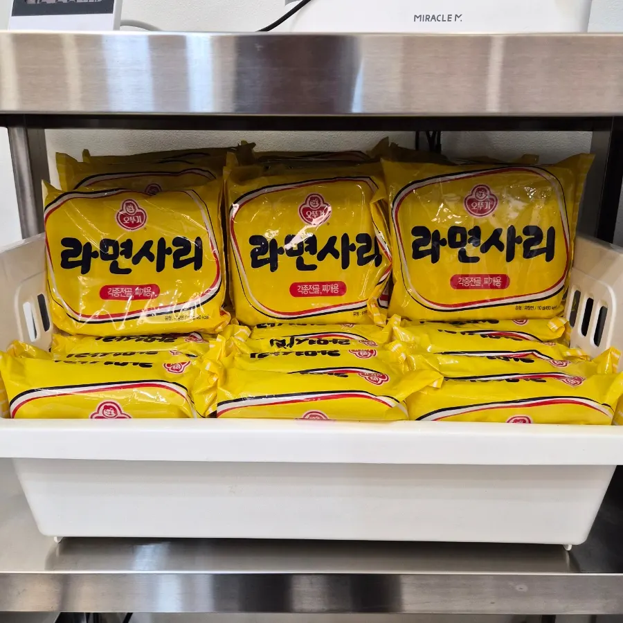 Ramyeon noodles added into the budae-jjigae broth and simmered