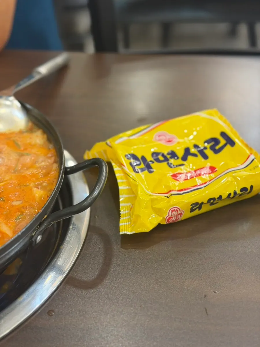Ramyeon noodles added into the budae-jjigae broth