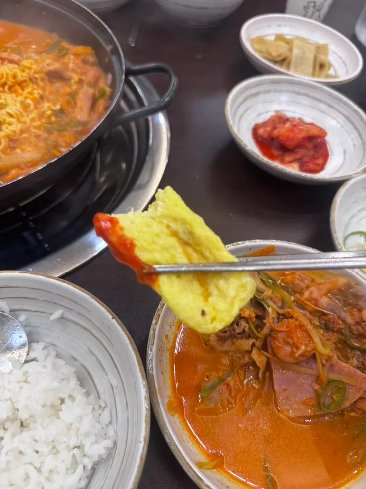 Egg roll served alongside budae-jjigae