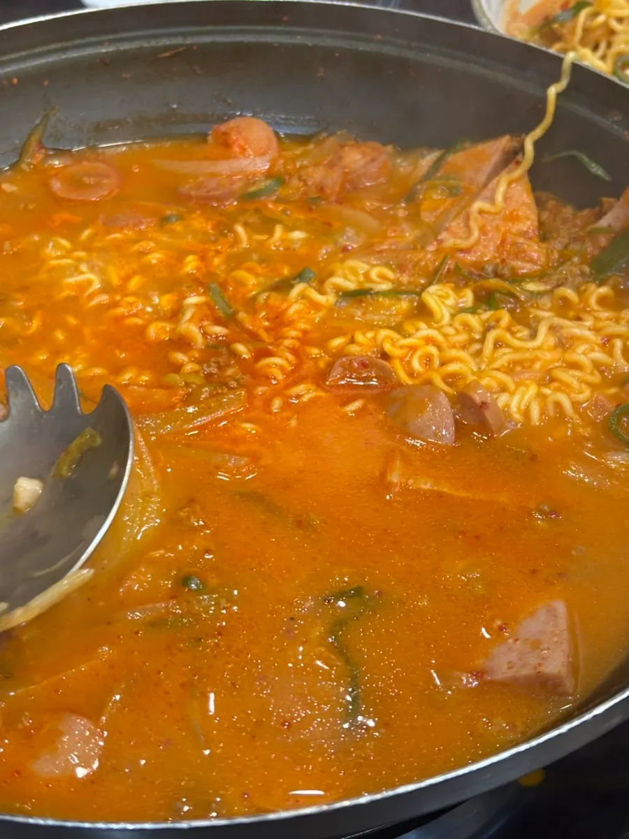 A bite of ham fished out of the budae-jjigae