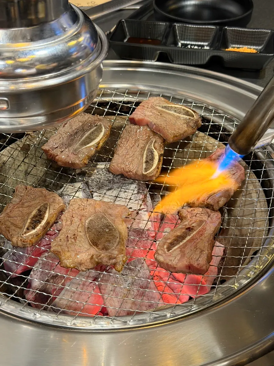 Torch-searing the beef short ribs for smoky flavor