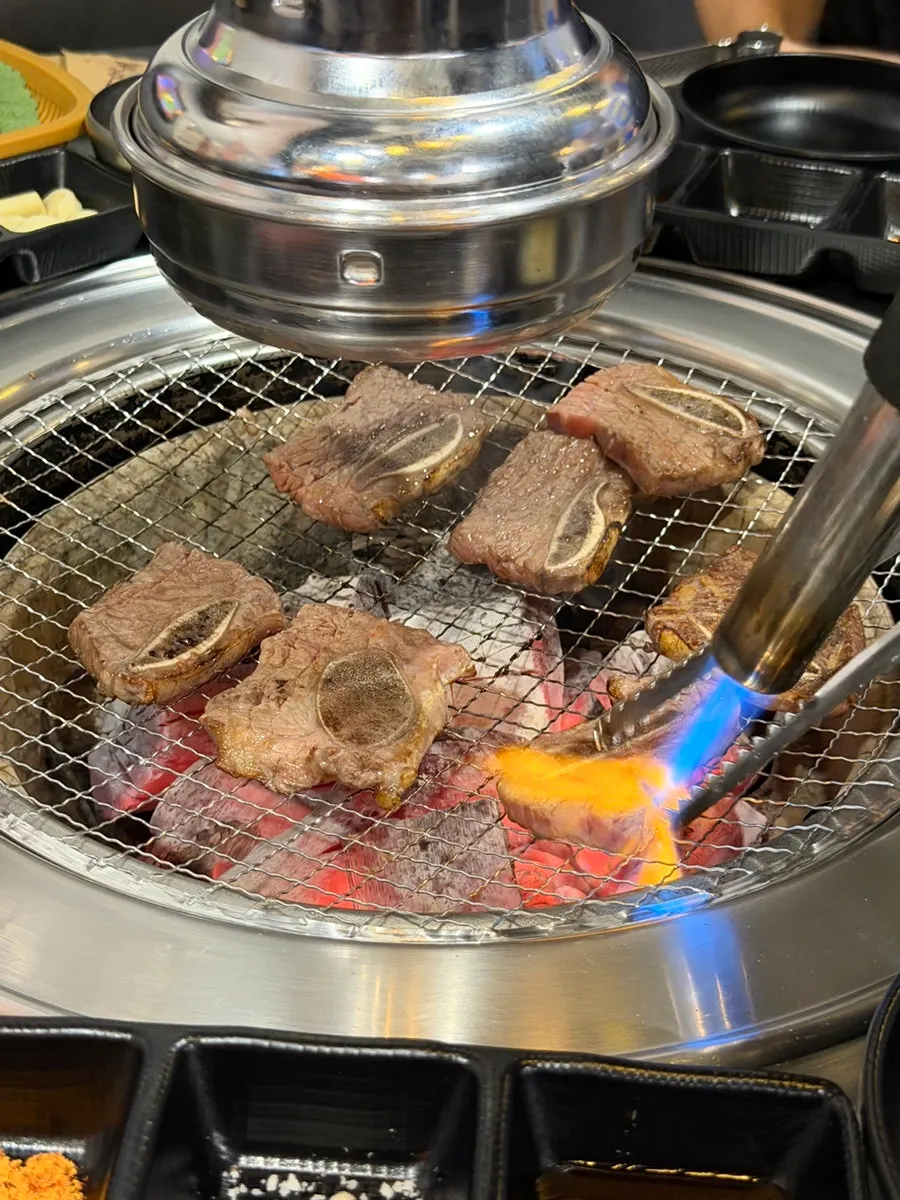 Torch searing the short ribs on the grill