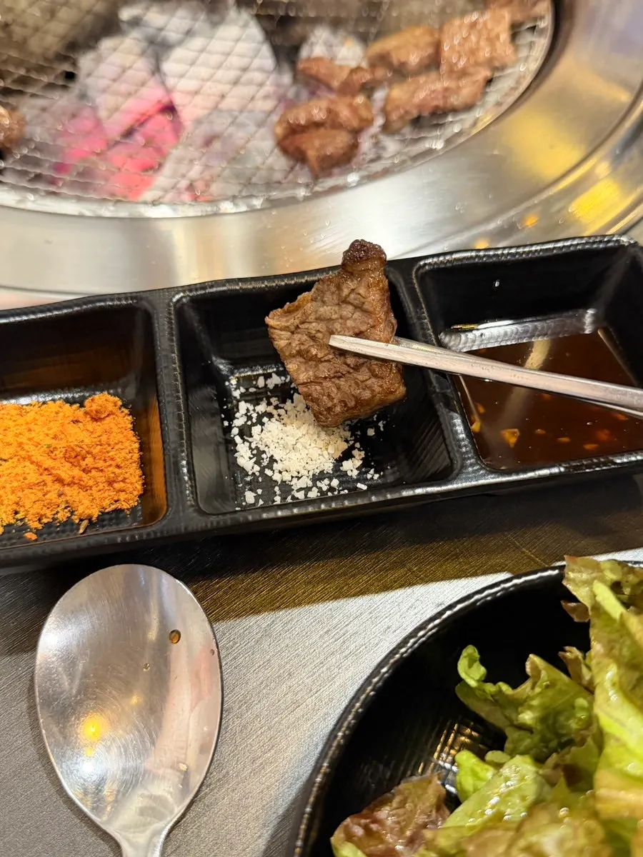 A piece of beef short rib dipped in salt
