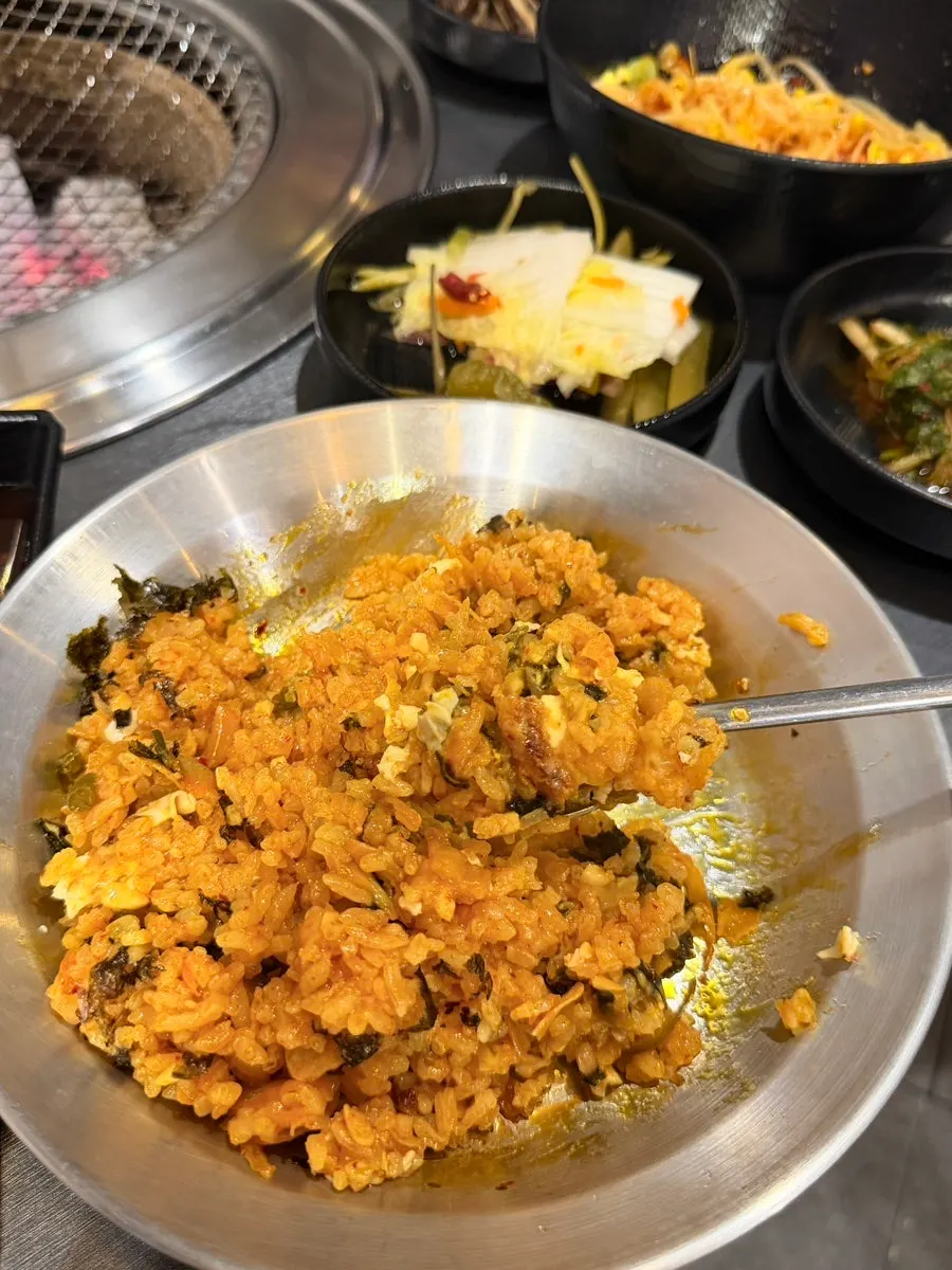 A spoonful of kimchi fried rice topped with cheese