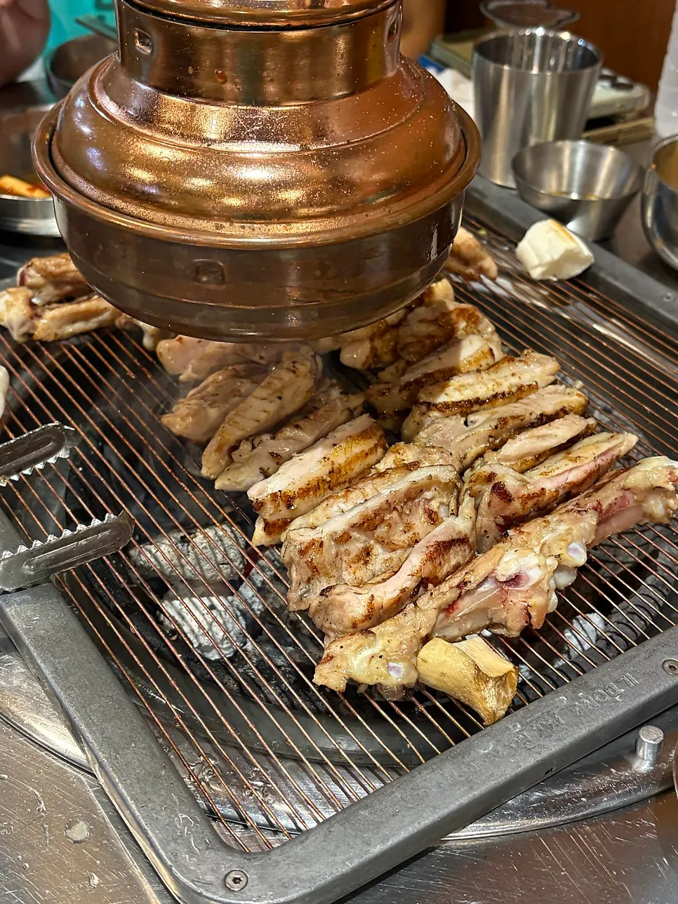 Chicken galbi cut up by a staff member with scissors