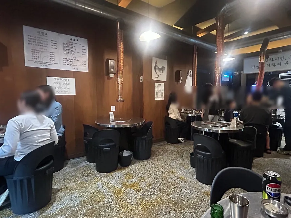 Interior of Ondogye with round tables and charcoal grills