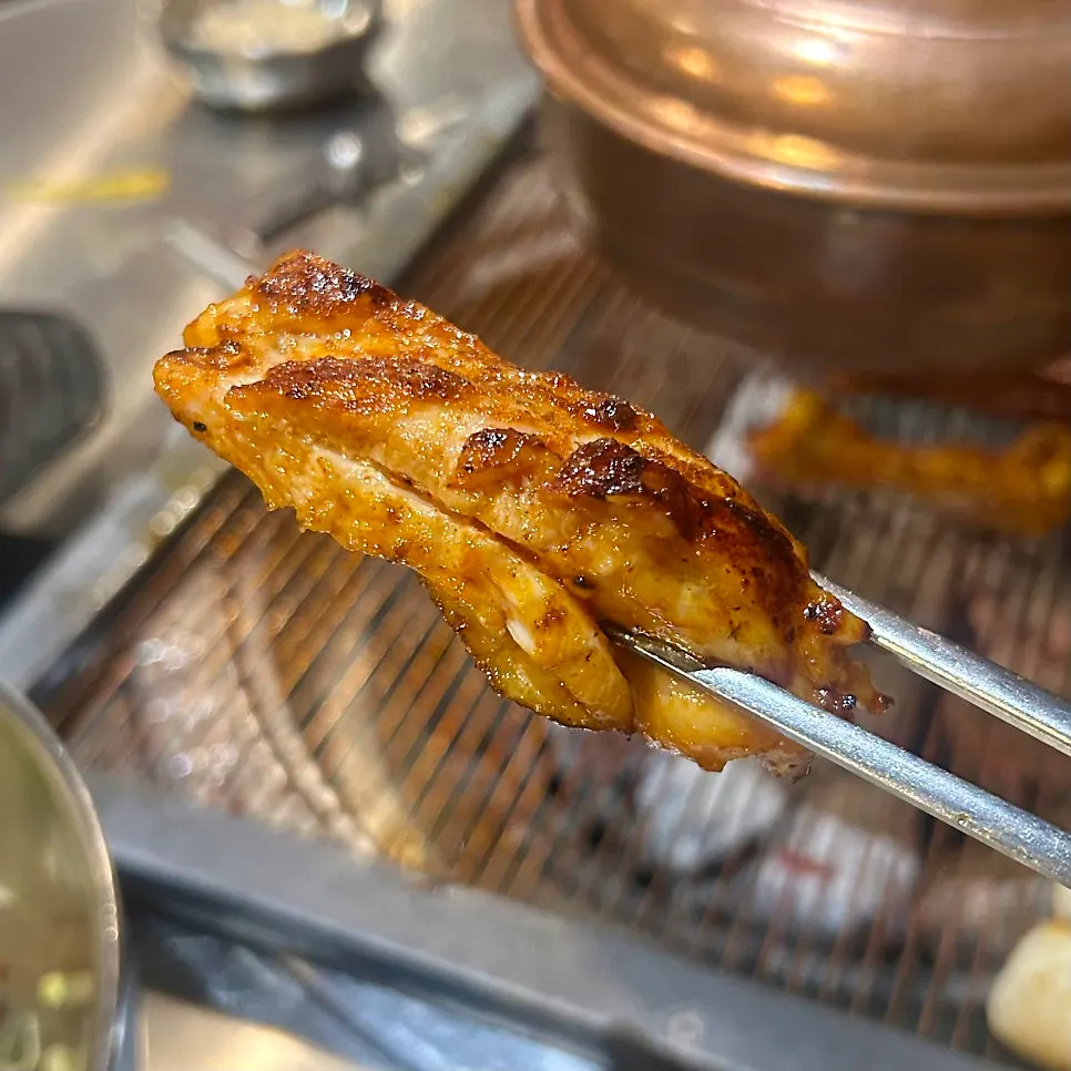 Close-up of chicken galbi coated in spicy marinade