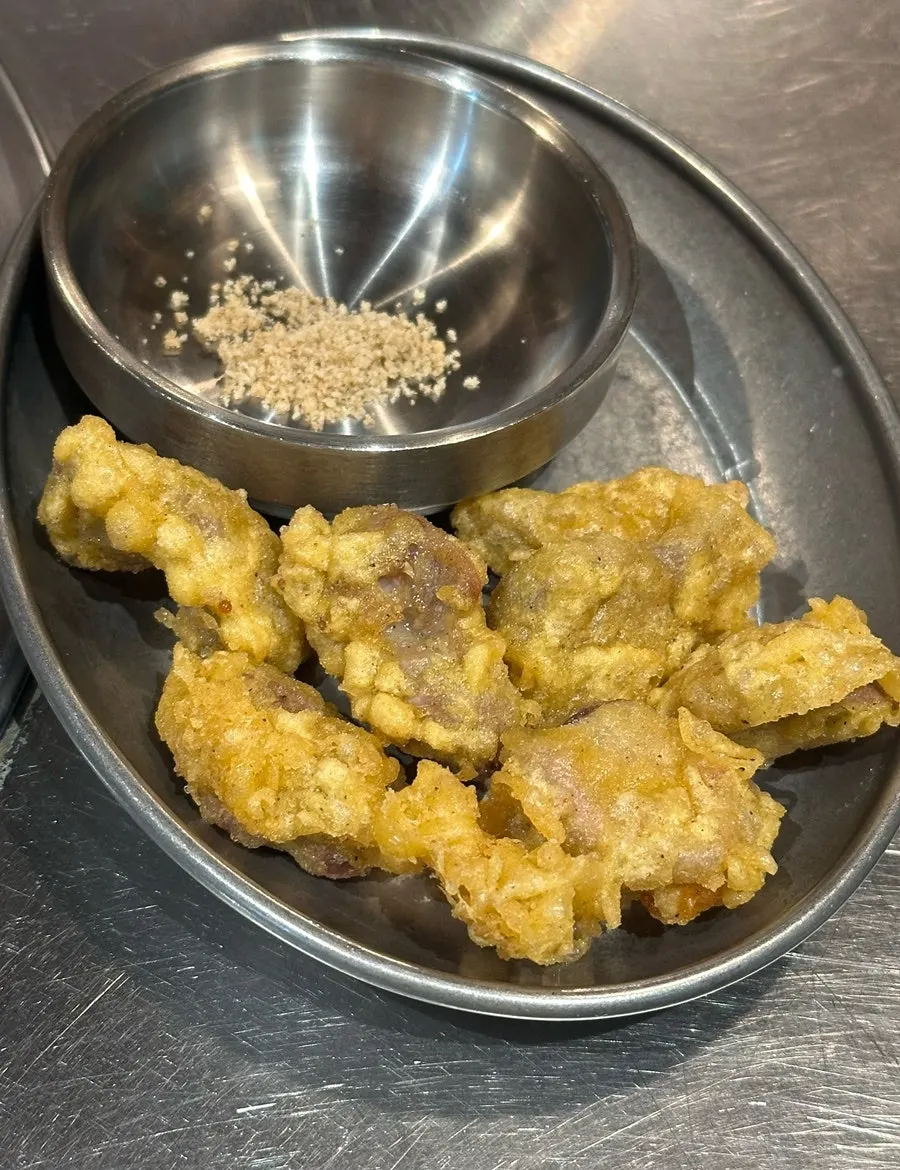 Complimentary fried chicken gizzards and sauces