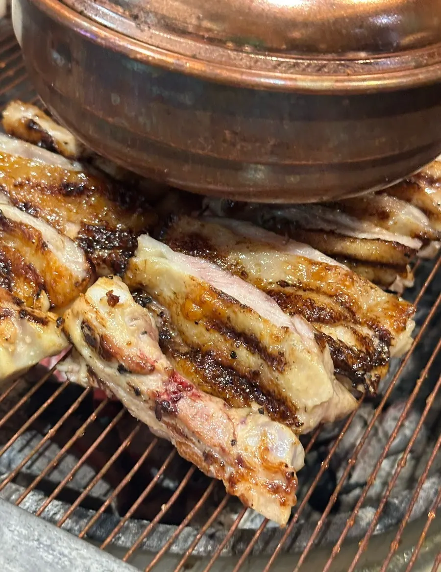 Staff grilling charcoal dakgalbi