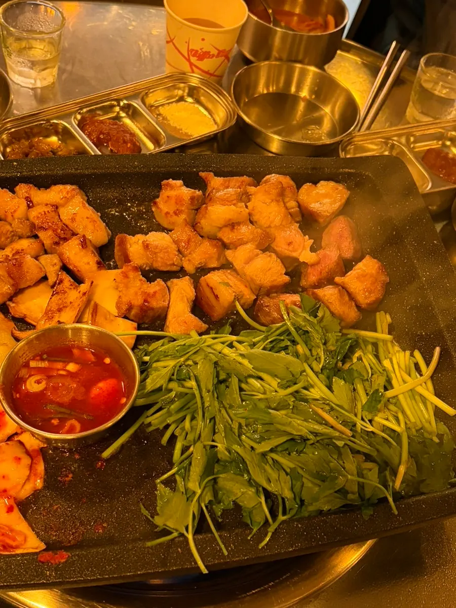 미나리와 함께 담은 구운 삼겹살 한 점