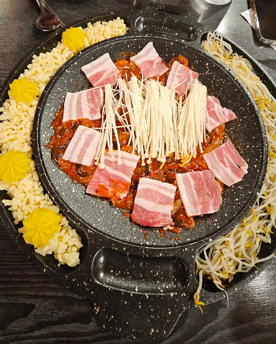 Owner cooking octopus and pork belly