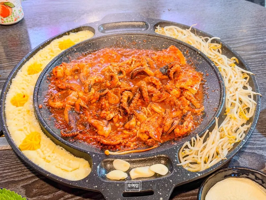 Staff member grilling the jjuksam
