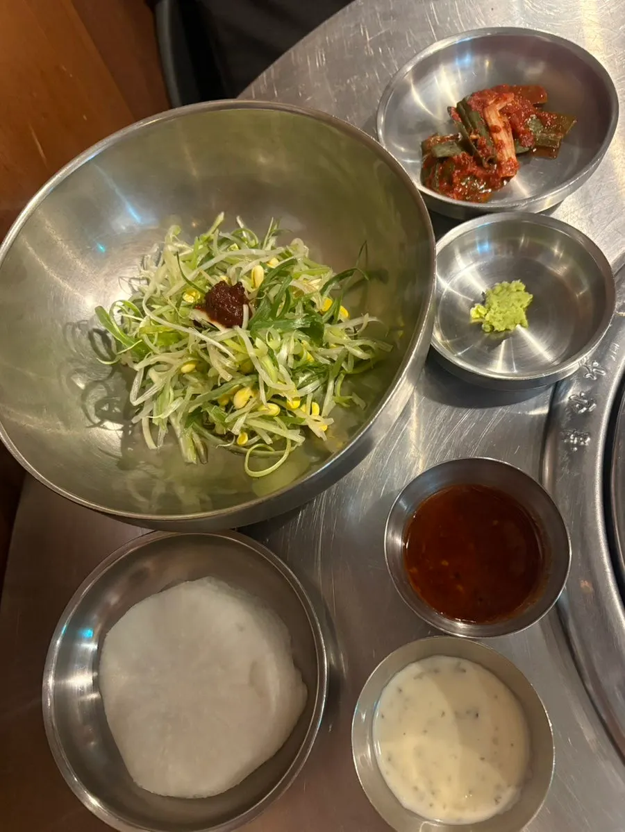 Basic table setting with sauce, pickled radish, and scallion salad
