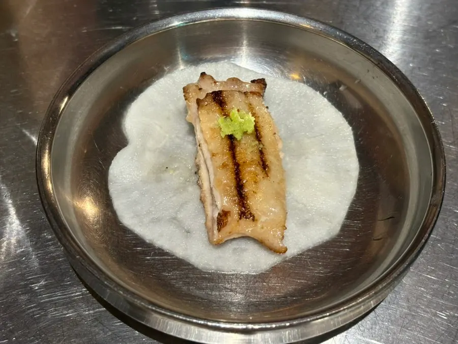 A piece of garlic salt chicken galbi dipped in salt