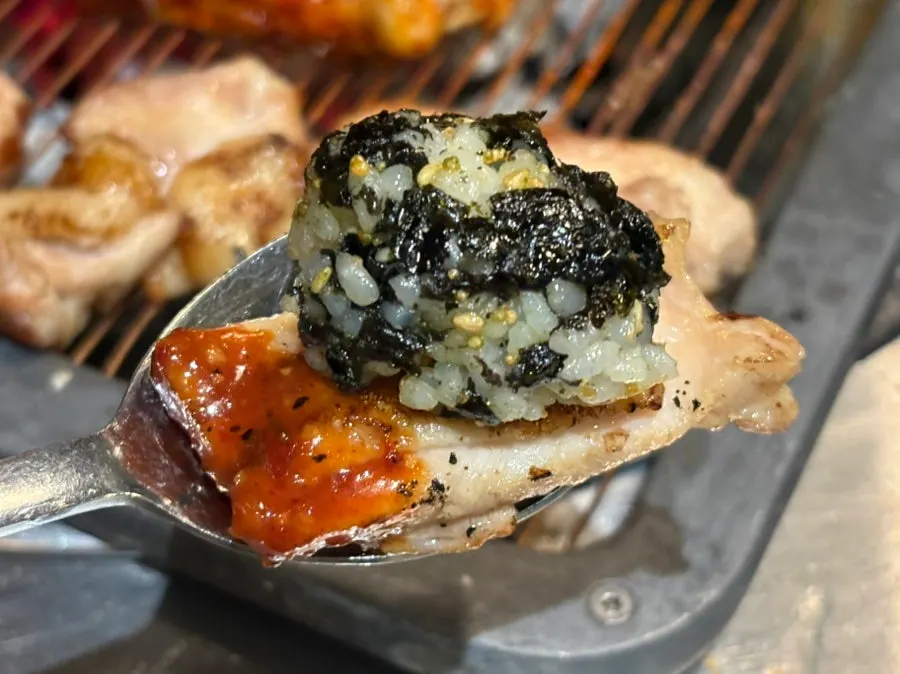 A grilled rice ball dipped in spicy sauce