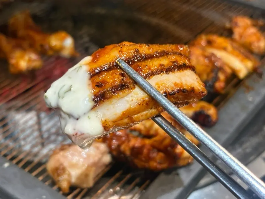 Spicy chicken galbi dipped in white sauce
