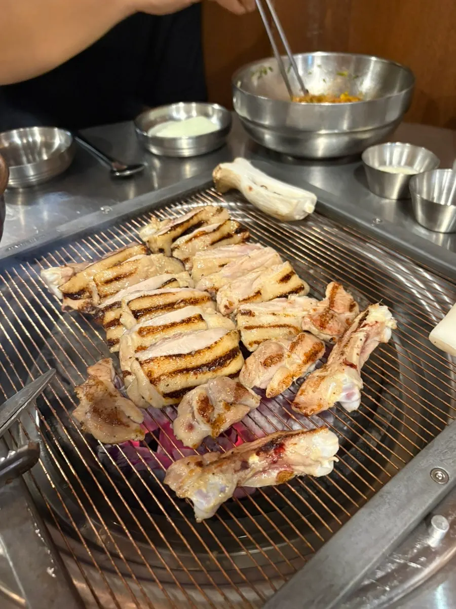 Charcoal chicken galbi placed on the heated grill plate