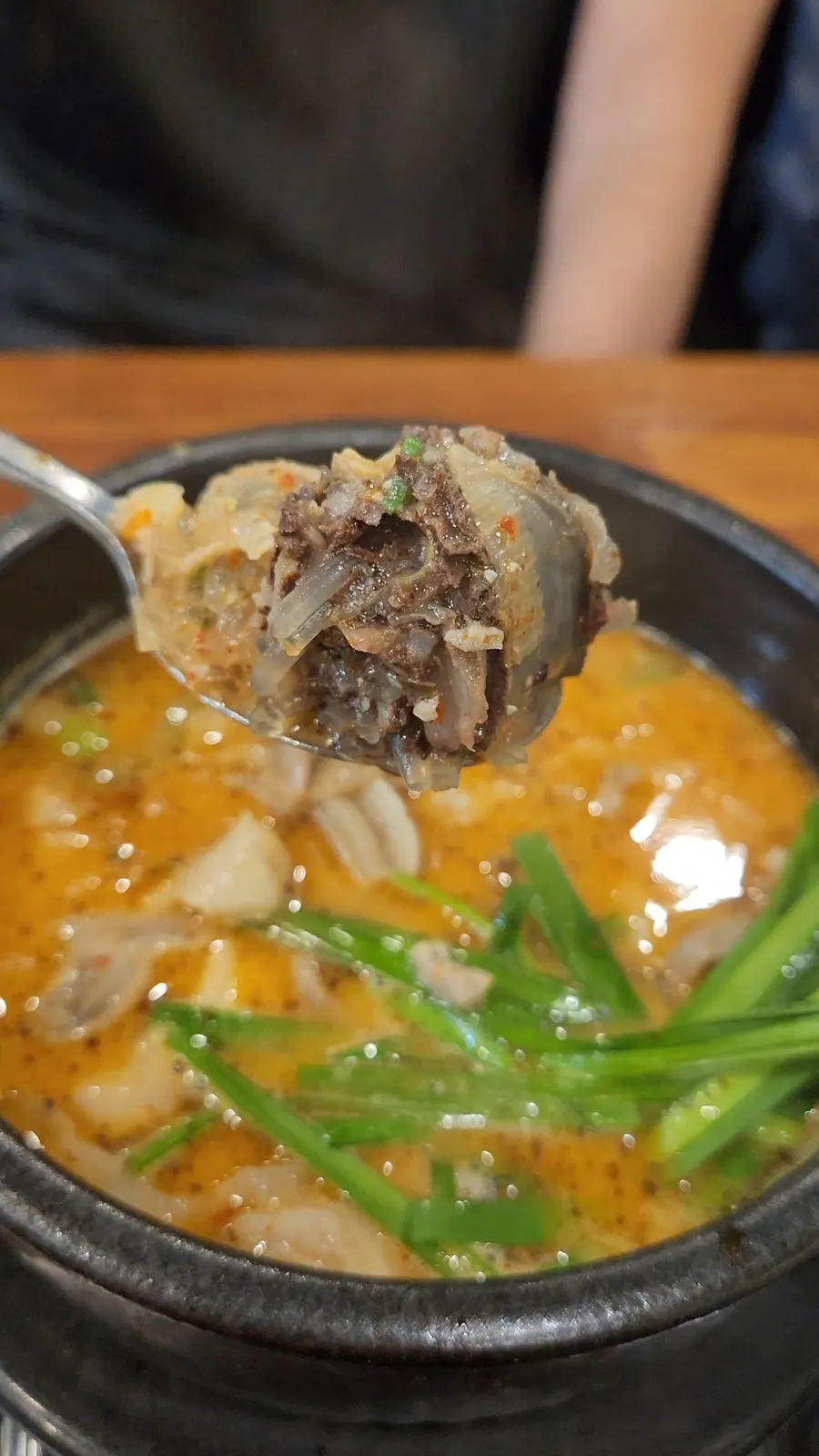 Rich sundae guk broth with chili paste stirred in
