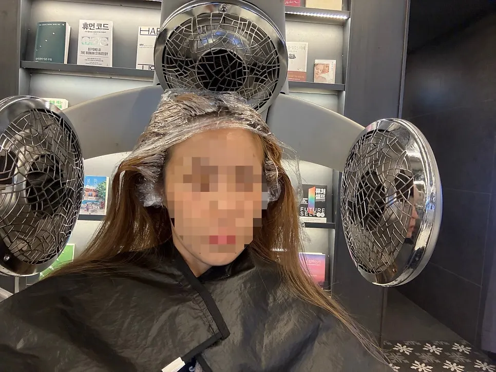 Grown-out dark roots against bright existing color