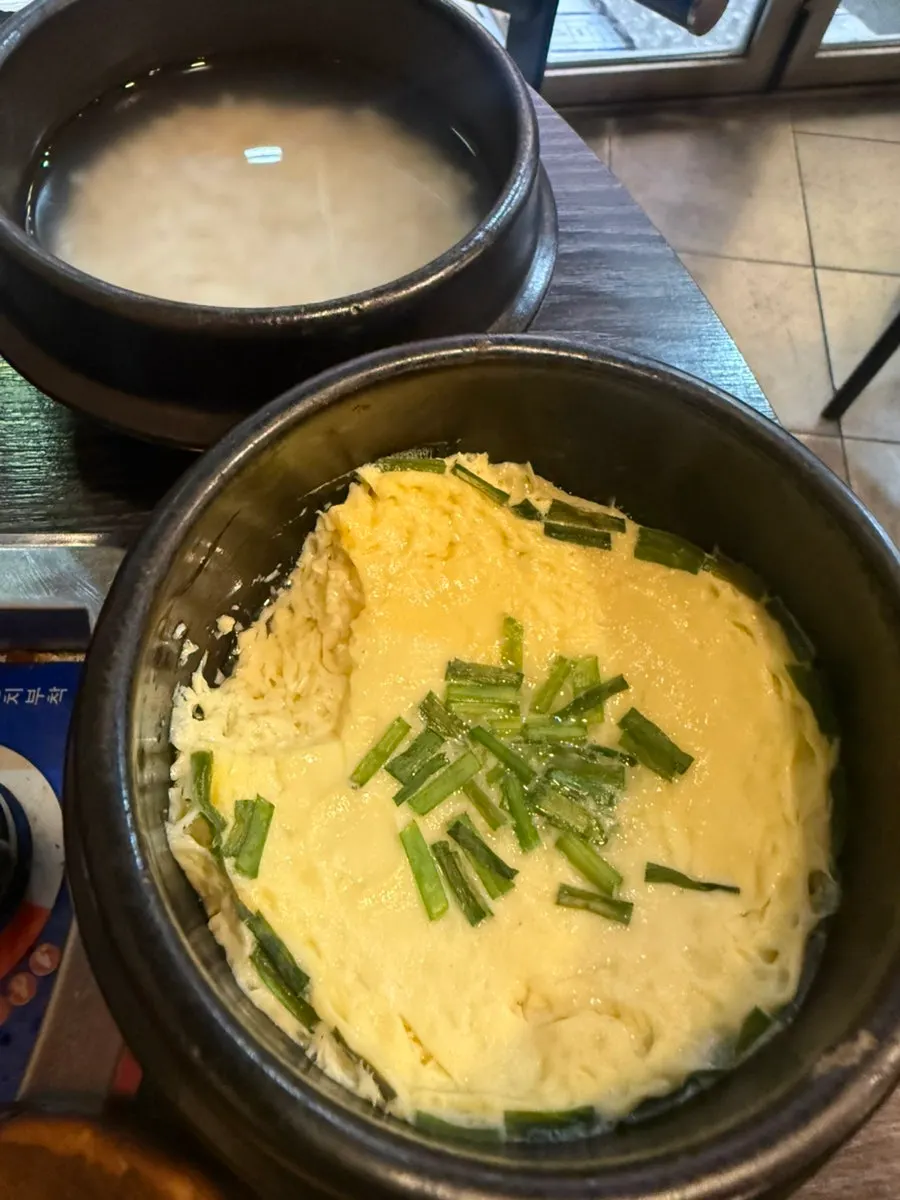 Egg and cheese around the edge of the griddle