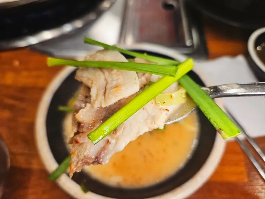 A ladle scooping up sundae hangjeong-suyuk broth
