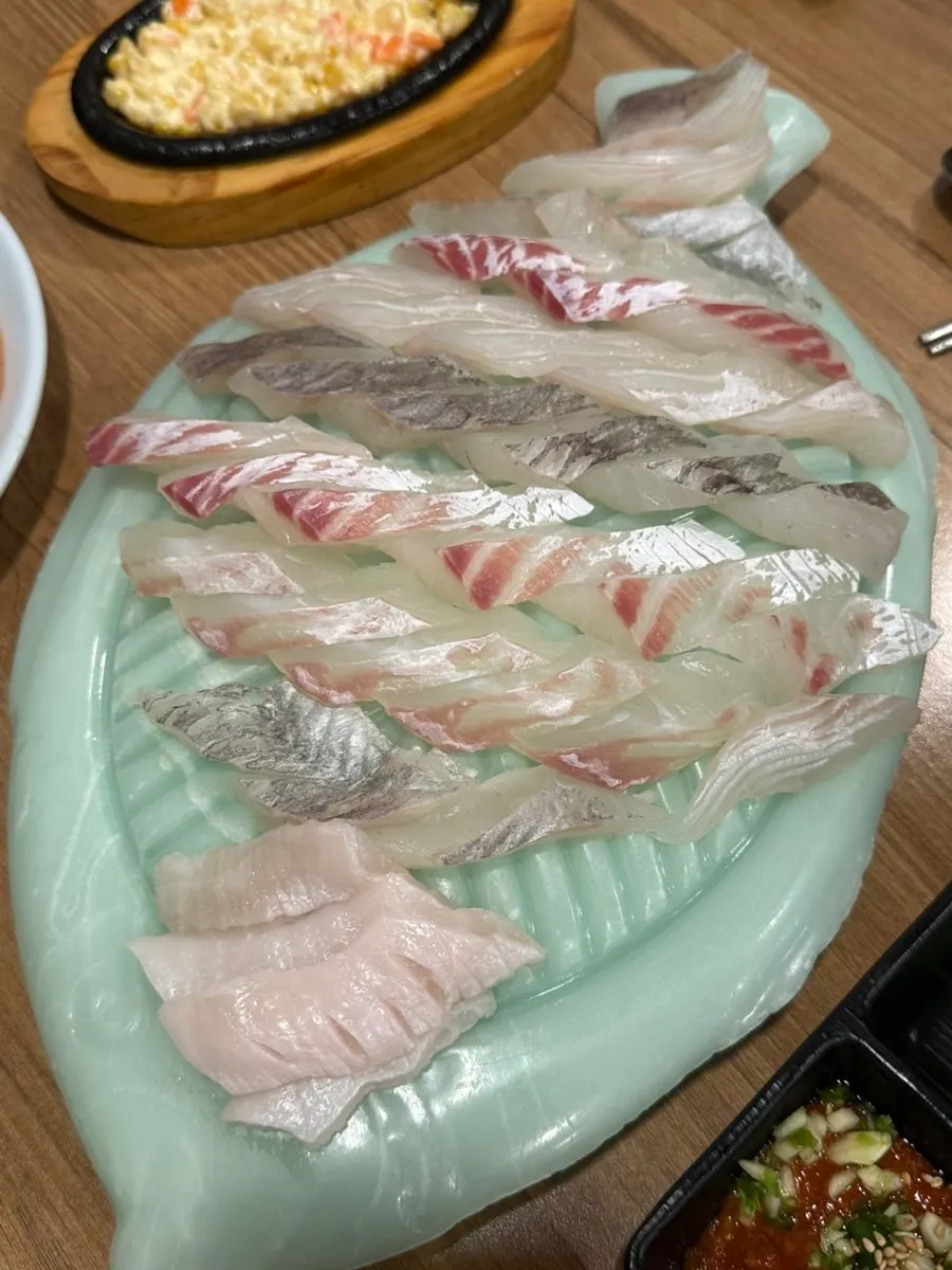Mixed raw fish platter with halibut, rockfish and sea bream on one plate