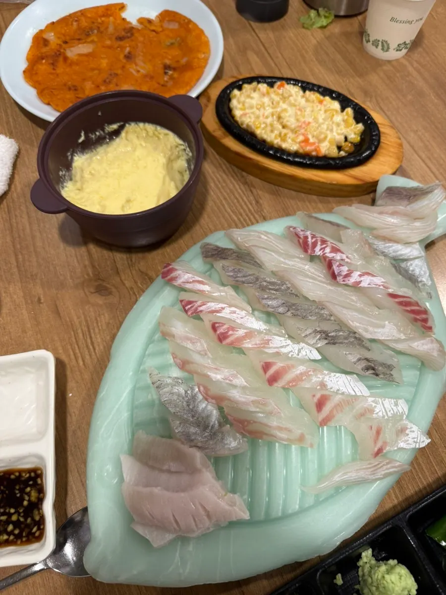 A piece of halibut dipped in soy sauce