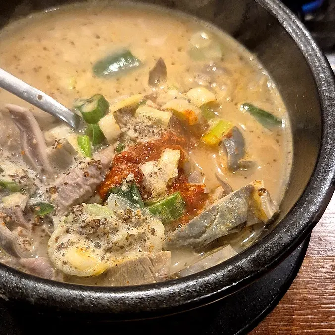 Milky broth from the pork jowl hot pot coming to a boil