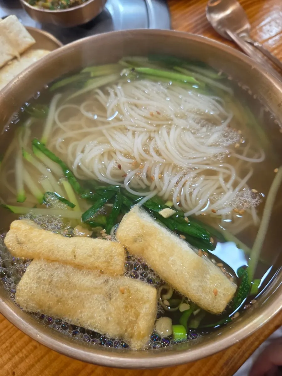 Noodle strands lifted with chopsticks