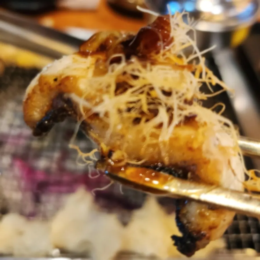 Eel sushi topped with ginger and wild ginseng-cultured root