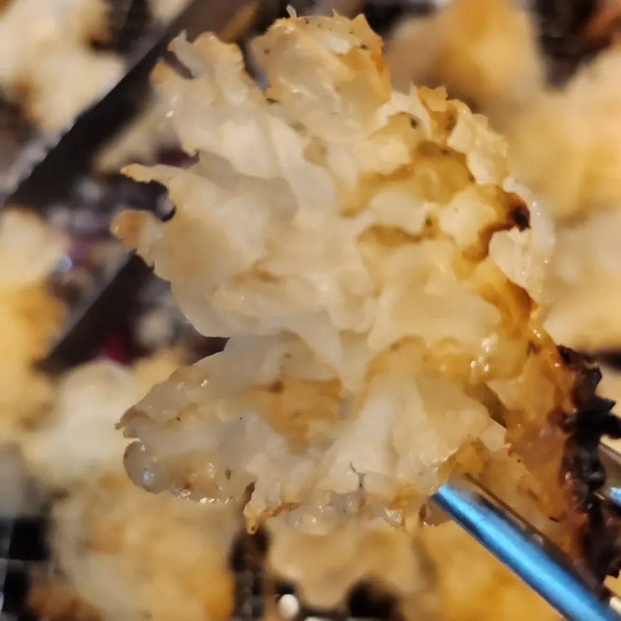 Snow mushroom (white tremella mushroom) grilling over charcoal