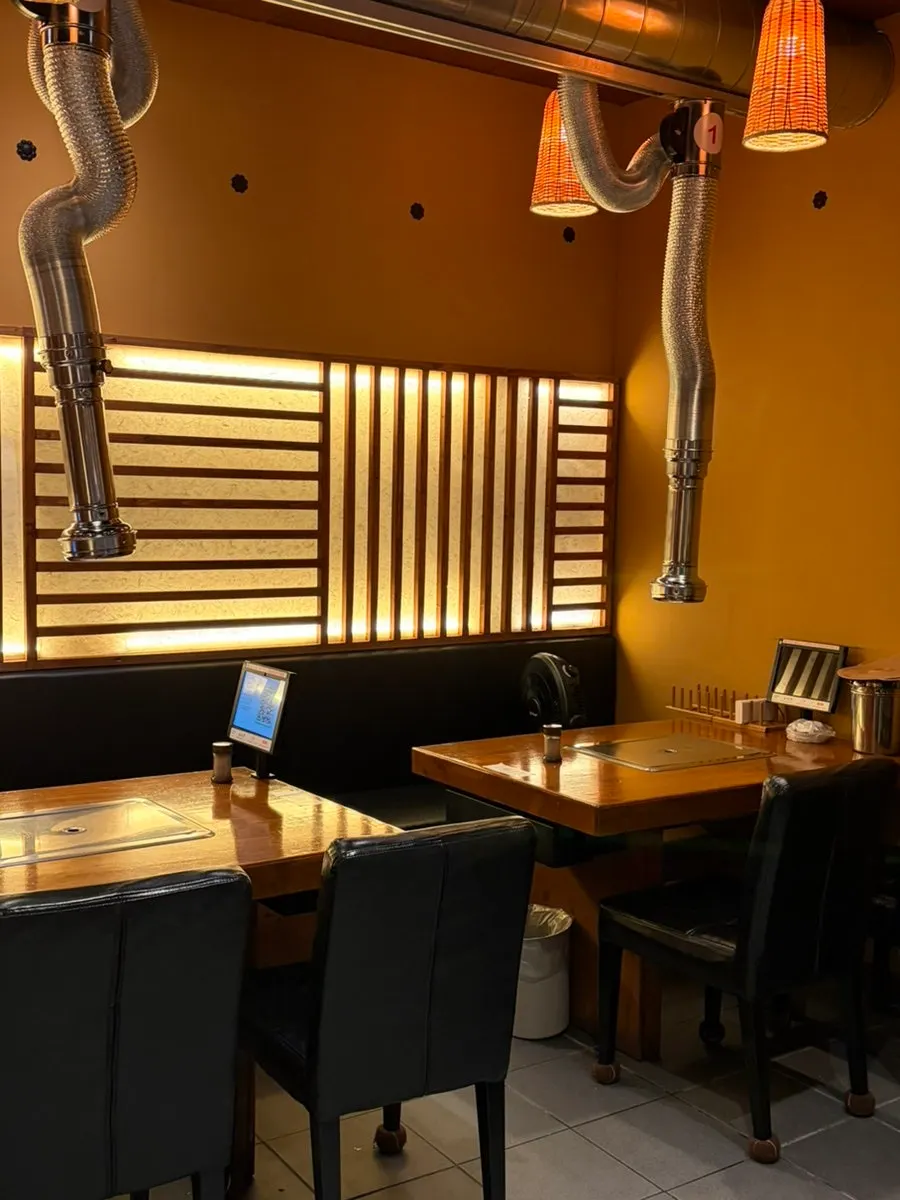 A family seated at an eel-grilling table