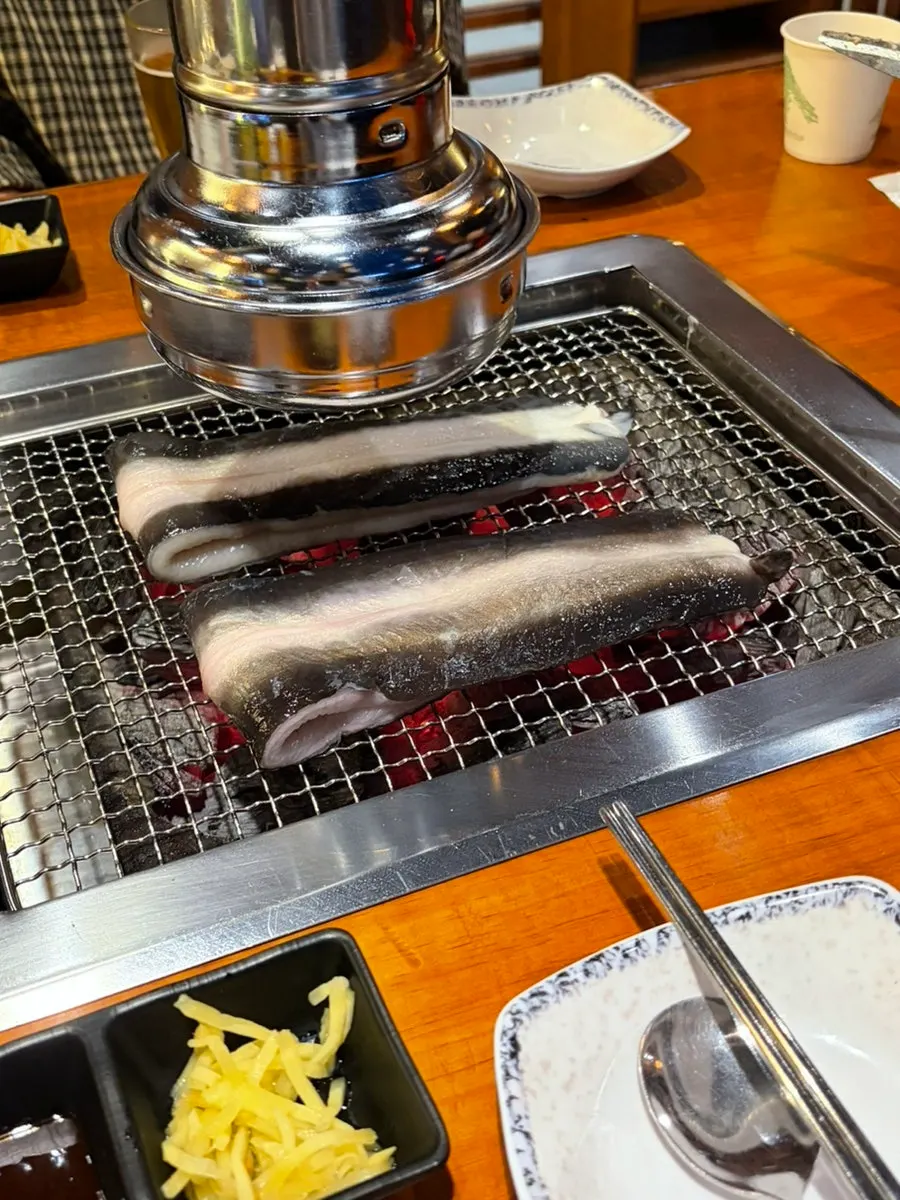 Freshwater eel placed on the charcoal grill to begin cooking